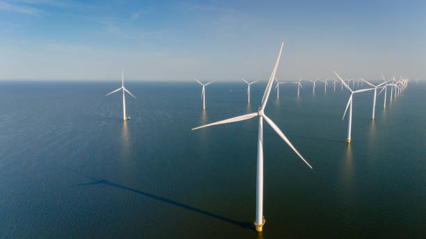 istock Majestic Windmill Park Overlooking Tranquil Dutch Waters at Sunrise 2165724772