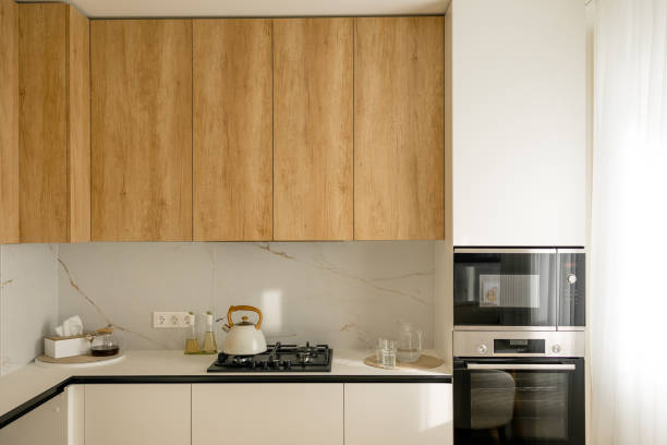 istock Modern white and wooden minimalist kitchen interior, home concept. modern oven, microwave 2165725788