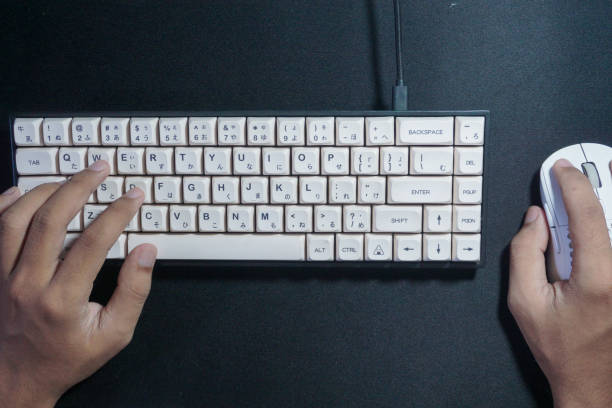 istock Closeup on the hand of a man using her computer, with a keyboard and a mouse 2165725875