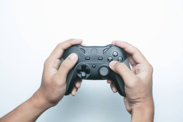 istock Hand holding a gamepad or joystick against a white background with empty copy space for text or advertisement 2165726039