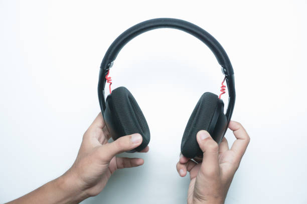istock Hand hold black wireless headphones 2165726772