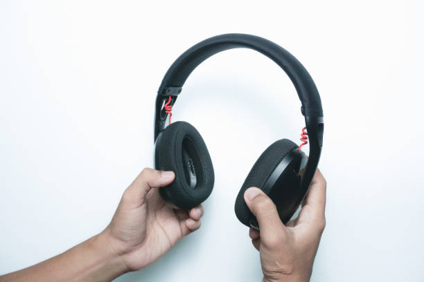 istock Hand hold black wireless headphones 2165726849