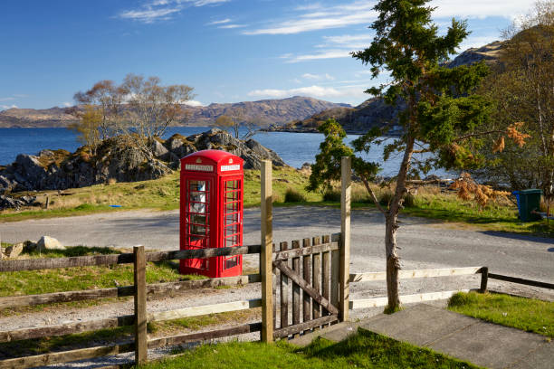 Glenuig, Moidart, Lochaber, Highland. 25th April 2024. With brightly painted red telephone kiosk, a crisp and sunny April morning view of Glenuig Bay from Viking Cottage. Glenuig, Scotland