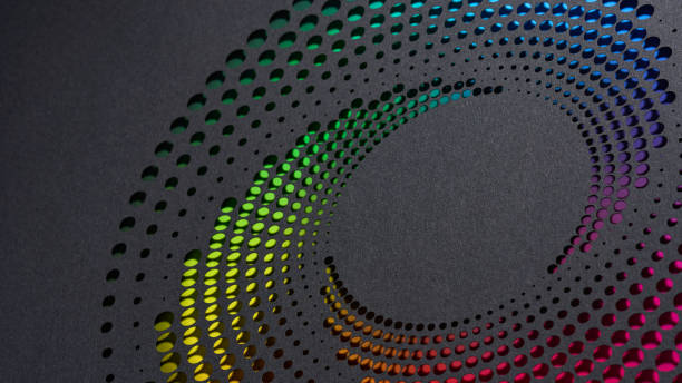 istock Vibrant Circular Paper Art with Rainbow Gradient Dots on Dark Textured Background 2165727379