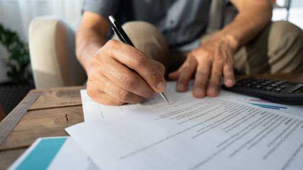 istock Senior man hand signing the contract 2165732407