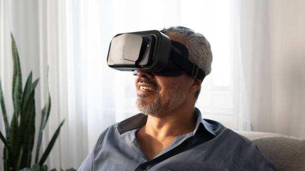 istock Senior man experiences VR glasses excitement at home 2165732726
