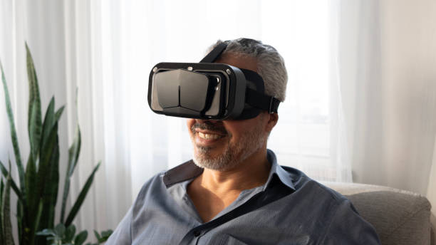 istock Senior man experiences VR glasses excitement at home 2165732732