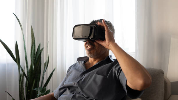 istock Senior man experiences VR glasses excitement at home 2165732735