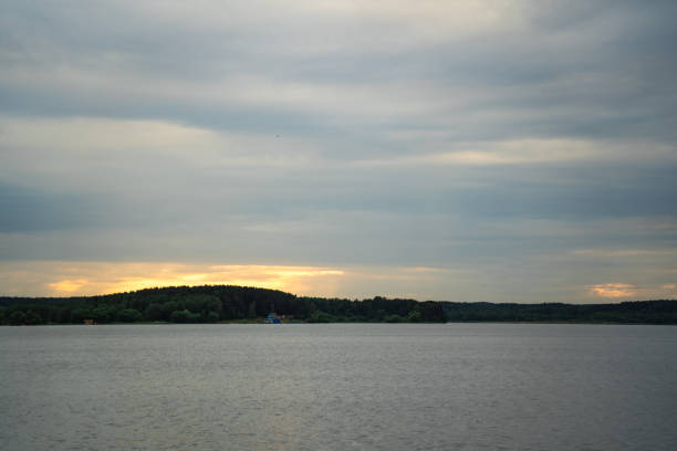 Sunset on the Minsk sea. Cloudy sky, calm. High quality photo