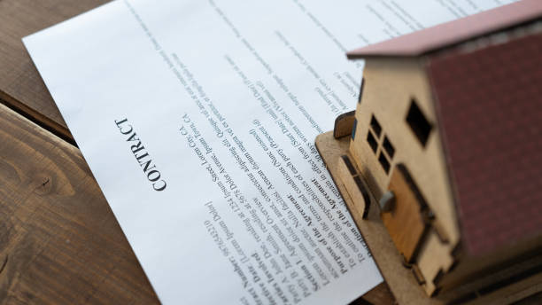 istock House contract and model house on the table 2165732839
