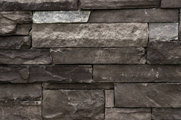 istock Dark monochrome brick stone wall full frame background. 2165735981