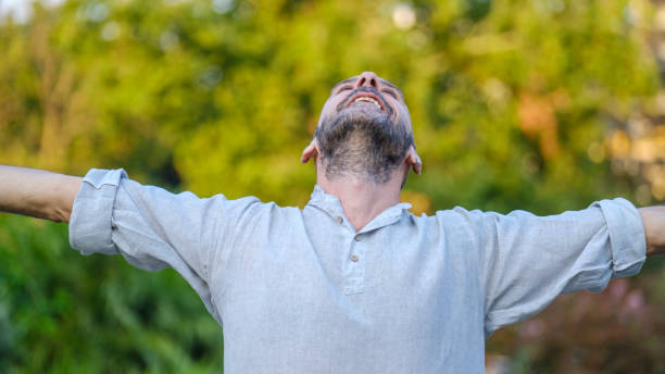 istock A middle-aged handsome businessman enjoying a stretch and relaxing his body while looking at the camera in a park 2165740762