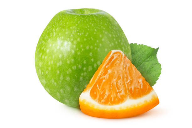 Green apple and orange slice on isolated white background.