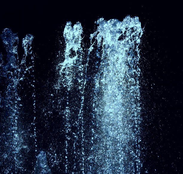 Water Jet With Blue Backlight Isolated On Black Stock Photo