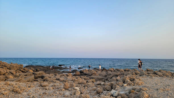 istock People walk on a beach full of stones 2165744639