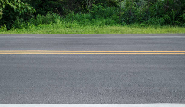 istock Side view of asphalt road with forest 2165752276