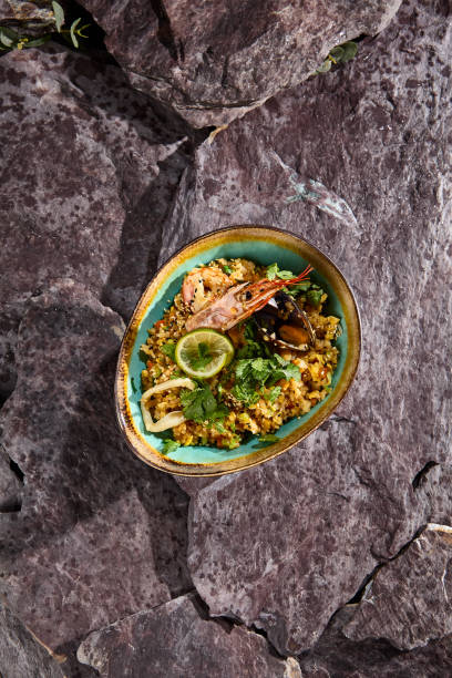 istock Asian-Style Fried Rice with Seafood on Stone Background Culinary Delight 2165752331