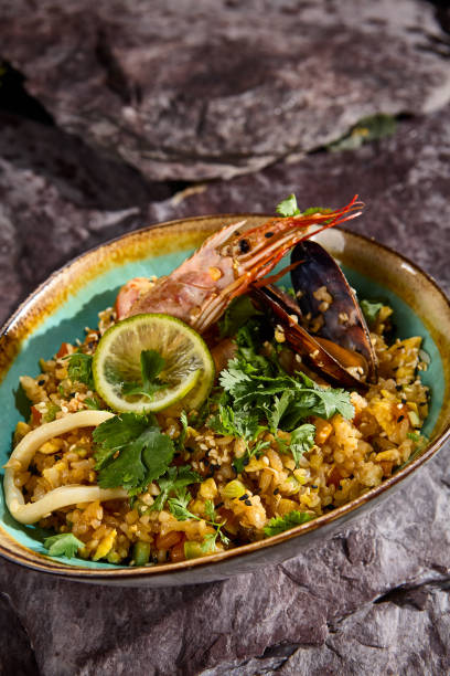 istock Asian Style Seafood Fried Rice on Stone Background 2165752386