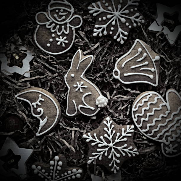 New Year's background with gingerbread. Christmas cookies and a garland on a craft background. Flat lay. Top View