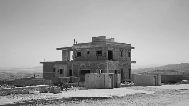 istock Unfinished Concrete Building Construction Site Monochrome Wide 2165753201