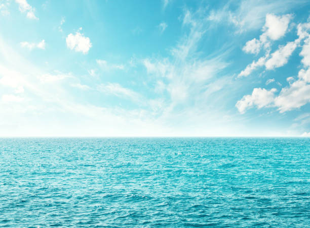 Summer landscape with a turquoise sea and a sunny sky filled with white clouds