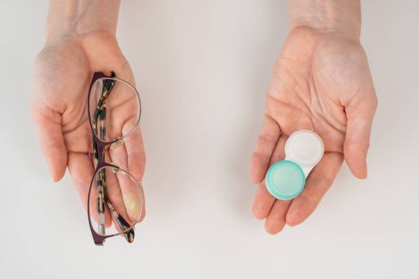 istock A woman makes a choice between lenses and glasses. 2165762997