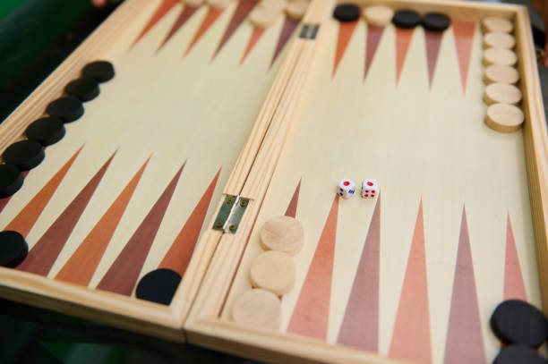 Two Females Playing Backgammon Throwing the Dices Hoping for Good Result