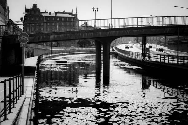 A canal through the city in black and white