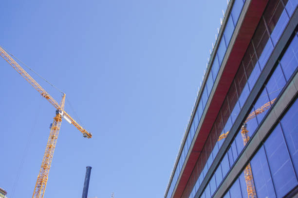 istock Low angle view of a building and a construction crane 2165772902