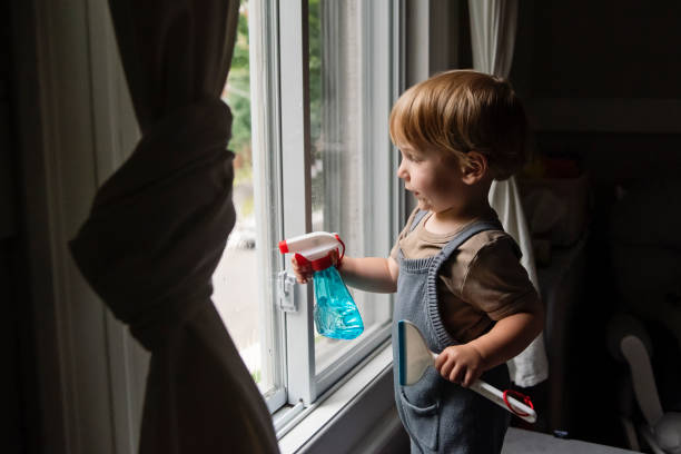 istock Cute toddler boy cleaning windows at home. 2165776487