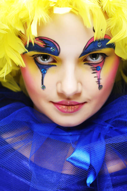 Young woman with yellow wig feather. Holiday theme.