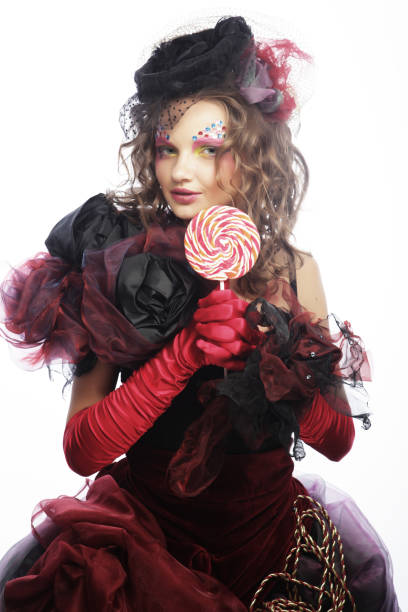 istock Girl with with creative make-up holds lollipop. 2165781273