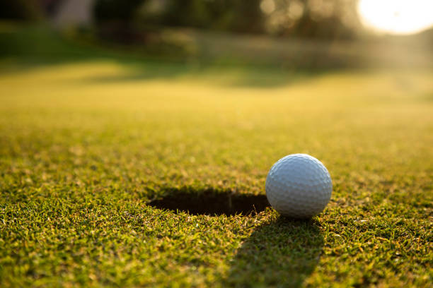 istock Closeup Golf ball on green grass on course 2165783286