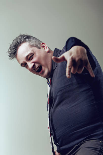 istock Evil greedy businessman making rock and roll gesture with hand 2165785749