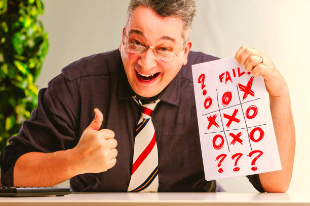 istock Evil manager celebrating fail showing thumbs up in office 2165788547