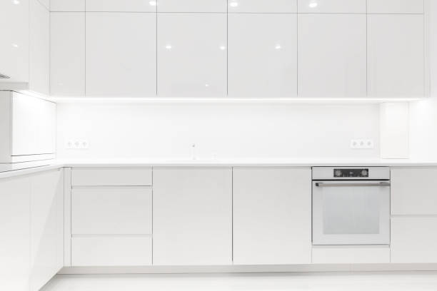 istock Front view of a modern luxury trendy snow white kitchen with many cabinets 2165790378