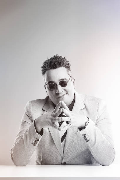 istock Sly salesman steepling fingers plotting business scheme 2165790560