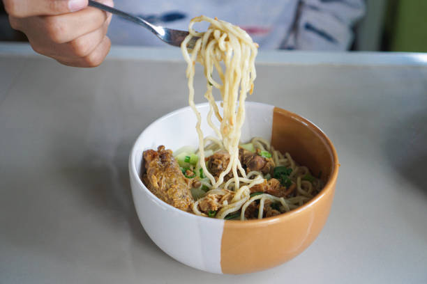 istock People eat chicken noodles using cutlery 2165792239