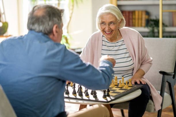 istock Elderly Couple Engages in Chess Match Indoors 2165794401