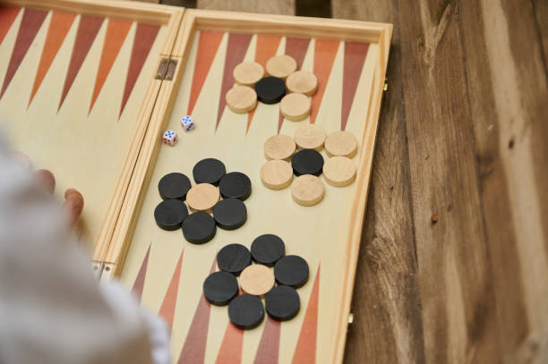 istock Backgammon game in progress outdoors on a wooden table on a sunny day 2165795076