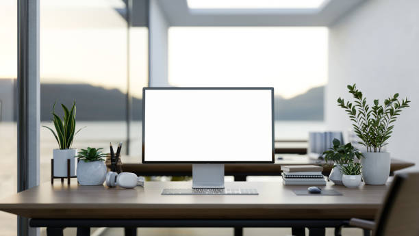 istock A computer desk in a modern office surrounded by large windows with a lake view, a computer mockup 2165799737