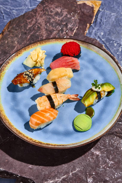 istock Exquisite Sushi Assortment with Salmon, Tuna, Perch, Shrimp, Eel, Scallop, and Avocado 2165806129