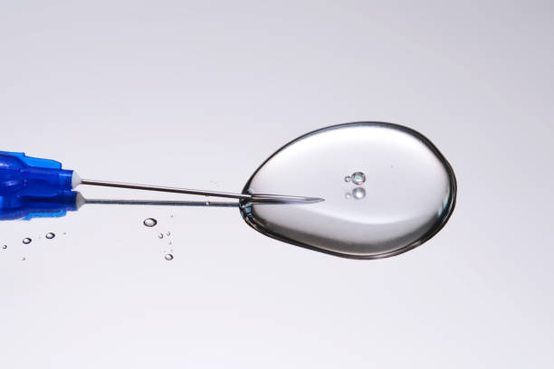 istock A drop of medicine flowing from a syringe with a needle. 2165808020