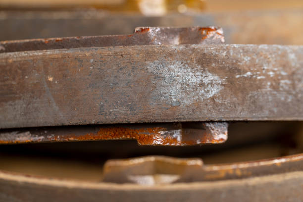 an old rusty brake disc from the car's brake system, parts of an old damaged car element