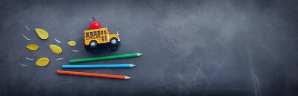 istock Back to school concept. bus and pencils over classroom blackboard. Top view 2165810229
