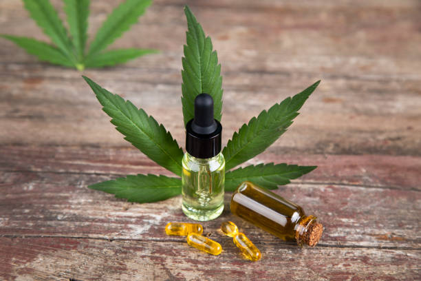 istock Hemp oil bottle with hemp leaf and cannabis leaf, marijuana 2165815782