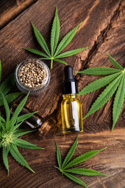 istock Cannabis oil bottle and marijuana leaves 2165816295
