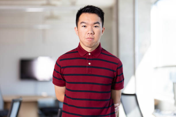 istock An shy nerd student standing in the school library 2165816298