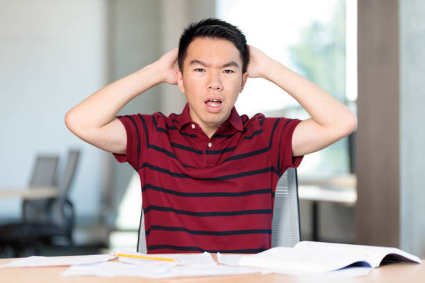 istock A stressed college student under homework and exam pressure 2165816392