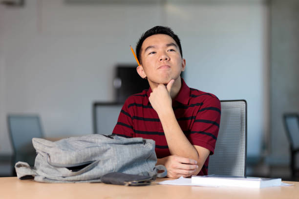istock A college student is daydreaming at a library table 2165816689
